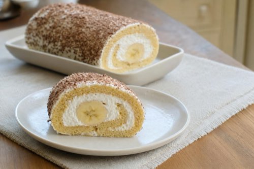 Banana cake roll with whipped cream and chocolate