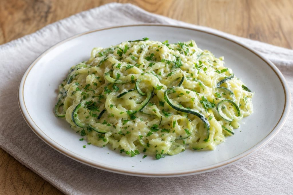 Zucchini noodles with cheese sauce and herbs