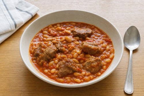 Braised pork neck with white beans and tomatoes