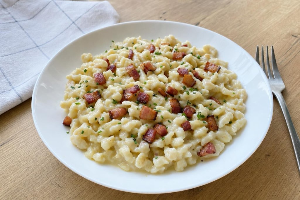 Halušky – Kartoffelnocken: Sie schmelzen 150 g Schmelzkäse mit Sahne auf Speck
