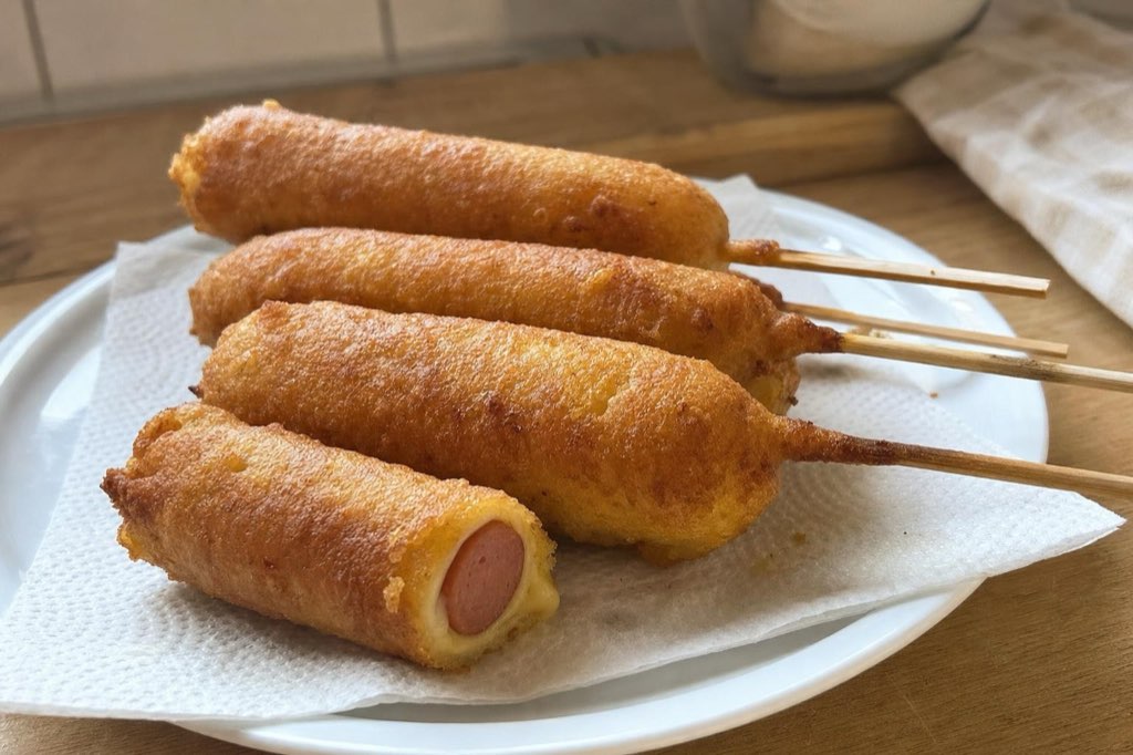 Cheese-wrapped corn dogs on sticks