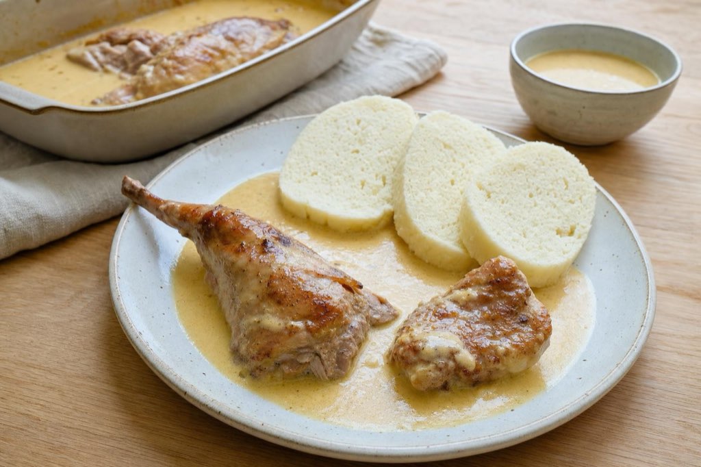 Rabbit in cream sauce with root vegetables: tender meat falls off the bone