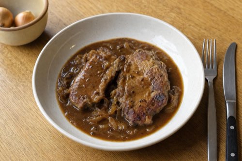Pork collar braised in dark beer with onions