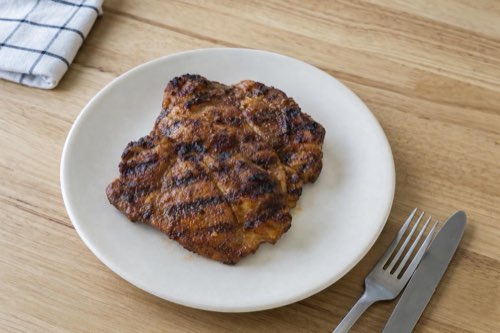 Garlic-marinated pork neck in a grill pan