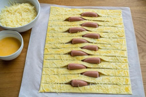 Cheesy hot dogs in woven puff pastry