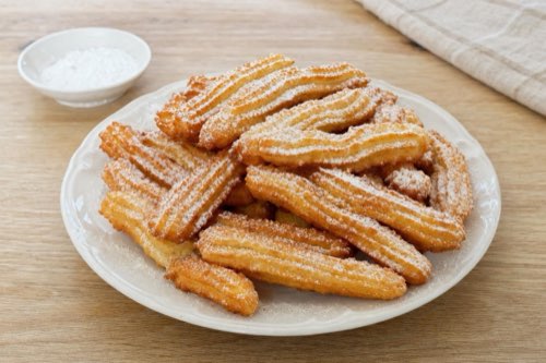 Fried choux pastry sticks with powdered sugar