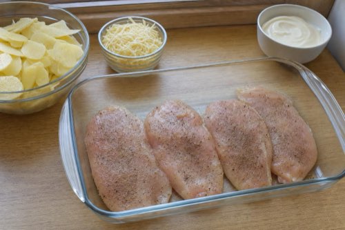 Baked chicken breasts with potatoes, cheese and mayonnaise